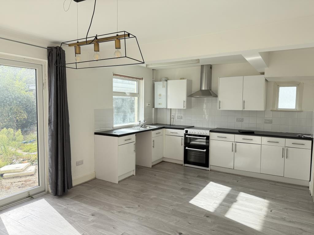 Lot: 124 - THREE-BEDROOM SEMI-DETACHED HOUSE - White fitted kitchen with dining area